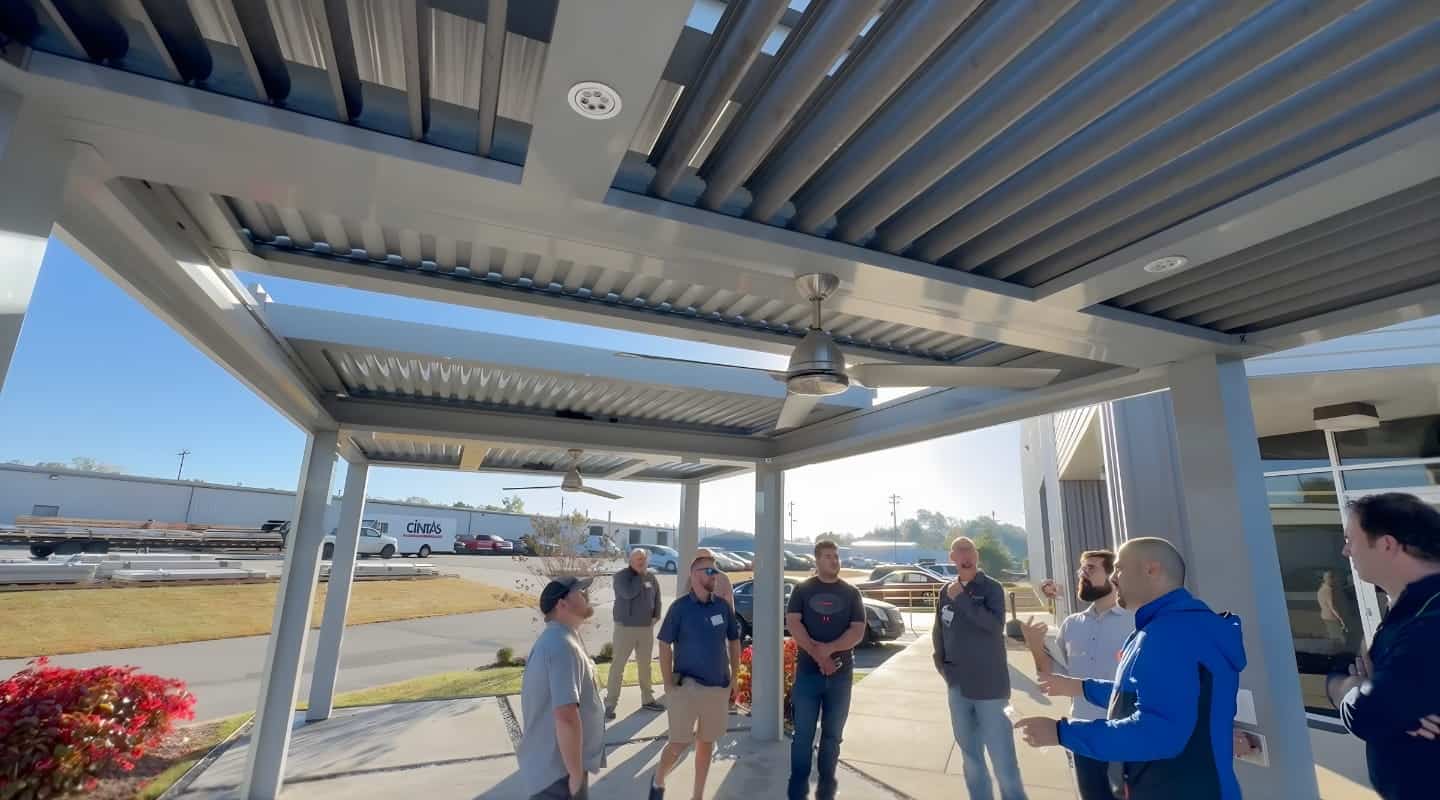 People discussing under a modern outdoor patio cover.
