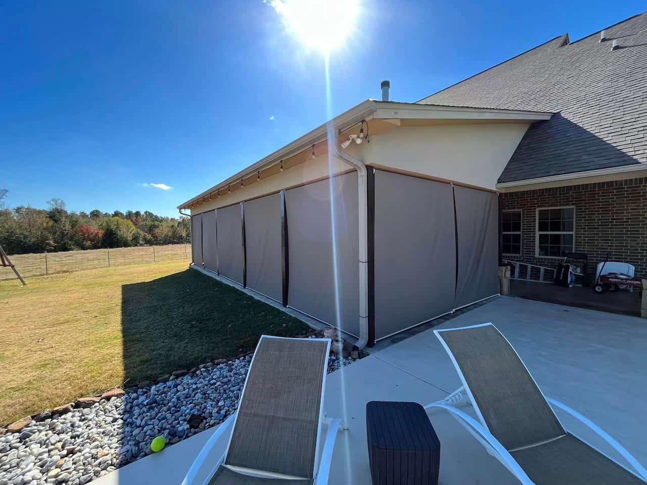 Motorized exterior shades for patio protection and privacy.