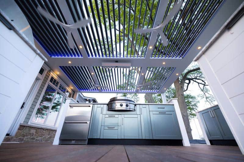 Outdoor kitchen featuring a stylish pergola and built-in grill for outdoor cooking and entertaining.